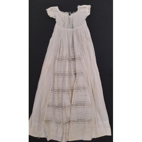 801 - A mixed textile lot comprising an early 20th century cotton nightgown, a long lace trimmed baby gown... 