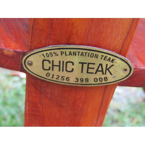 1196 - Two good quality contemporary teak garden chairs of varying design with slatted seats and backs toge... 