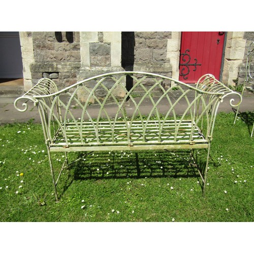 1152 - A Regency style weathered cream painted steel two seat garden bench with open strapwork seat, scroll... 