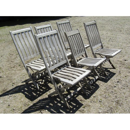 1094 - Six weathered teak folding garden chairs with slatted seats and backs (set of five plus one similar)... 