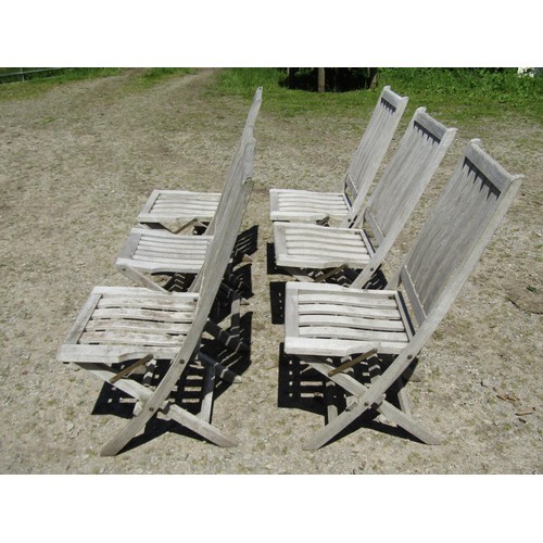 1094 - Six weathered teak folding garden chairs with slatted seats and backs (set of five plus one similar)... 