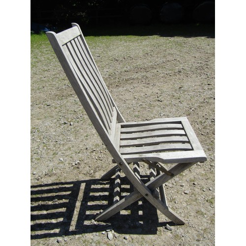 1094 - Six weathered teak folding garden chairs with slatted seats and backs (set of five plus one similar)... 