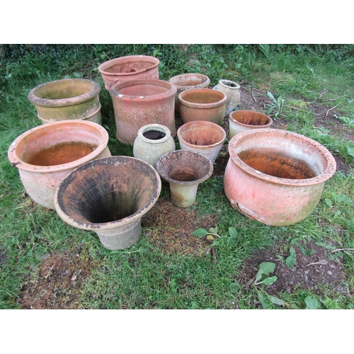 1079 - Fourteen weathered terracotta planters of varying size and design (some af)