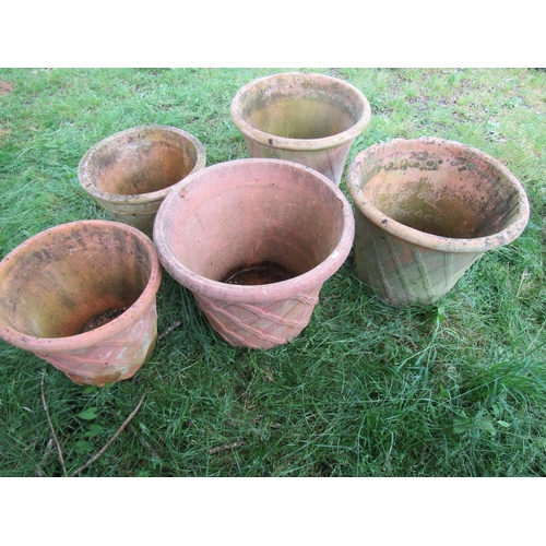 1080 - Four similar weathered terracotta garden planters in the form of lattice baskets, the largest exampl... 