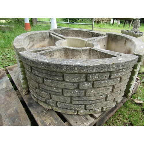 1101 - A Sandford cast composition stone  four sectional garden planter forming a circle with mock stone wa... 