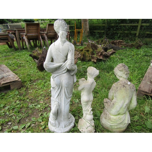 1103 - Three weathered cast composition stone garden ornaments in the form of classical maidens in varying ... 