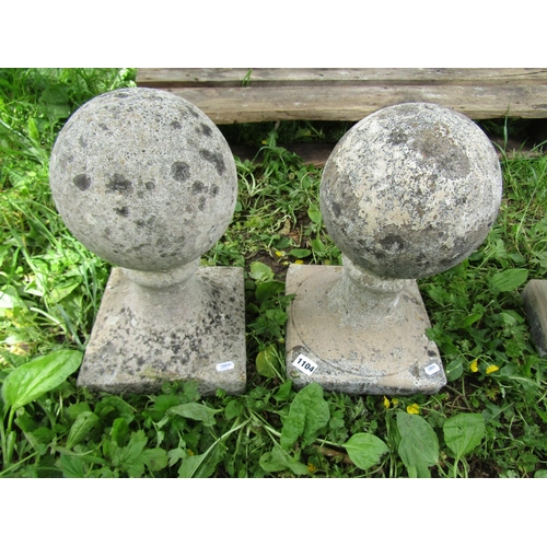 1104 - A pair of cast composition stone pier caps with fixed sphere finials approx 20 cm in diameter x 40 c... 