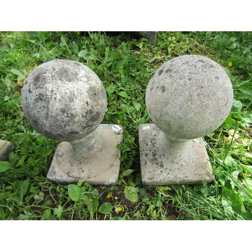 1104 - A pair of cast composition stone pier caps with fixed sphere finials approx 20 cm in diameter x 40 c... 