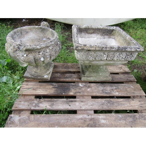 1106 - A weathered cast composition stone garden urn, the squat lobed bowl with open scrolled handles raise... 