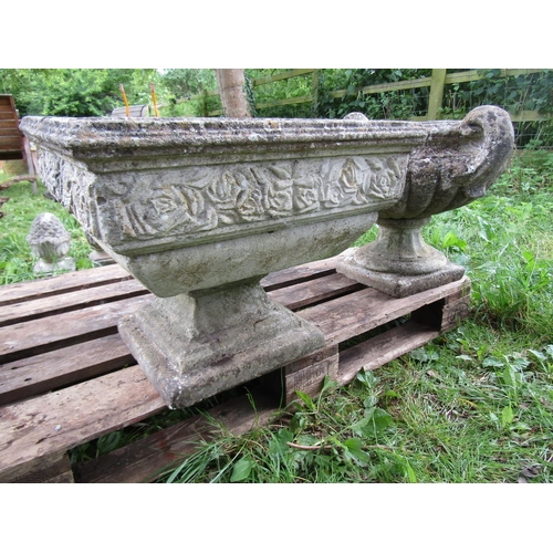 1106 - A weathered cast composition stone garden urn, the squat lobed bowl with open scrolled handles raise... 