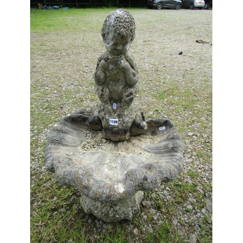 1109 - A weathered cast composition stone bird bath in the form of a shell with seated pan surmount, 75 cm ... 