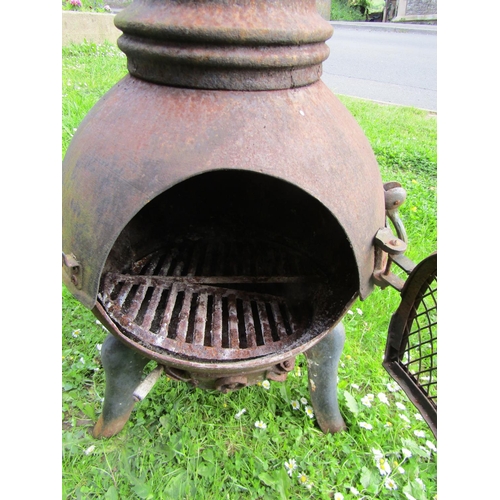 1156 - A weathered cast iron chimenea with drop ring handles 122 cm (4ft high)