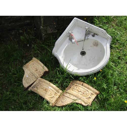 1174 - A Victorian ceramic corner washbasin and wall mounted cast iron bracket in three sections with raise... 