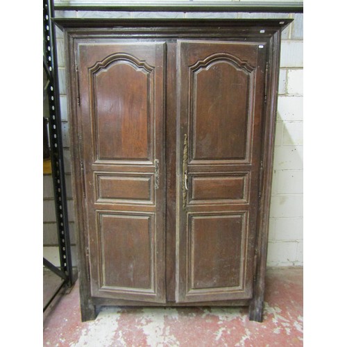 1679 - An 18th century oak armoire enclosed by a pair of full length fielded panelled doors within a panell... 