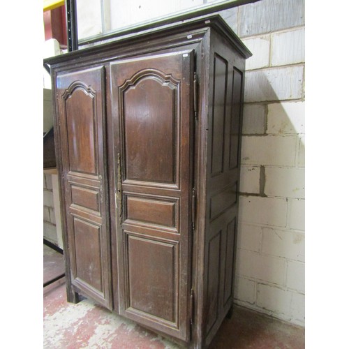 1679 - An 18th century oak armoire enclosed by a pair of full length fielded panelled doors within a panell... 