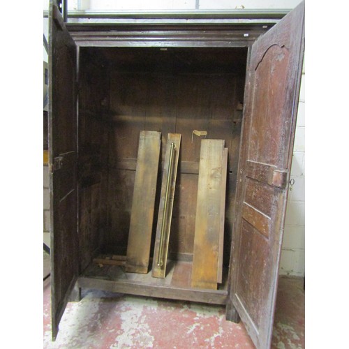 1679 - An 18th century oak armoire enclosed by a pair of full length fielded panelled doors within a panell... 