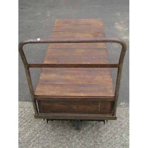 1687 - A vintage four wheeled platform trolley with wooden bed and tubular steel handle, the bed 130 x 56 c... 