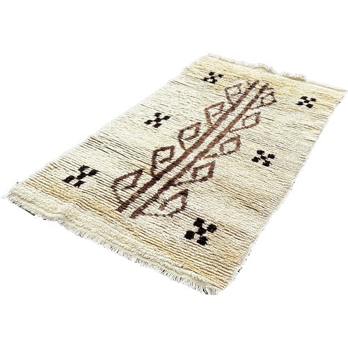 1759 - A Tulu Rug from Turkey with a cream tuffty pile with a central abstract pattern, 190 x 108cm approxi... 