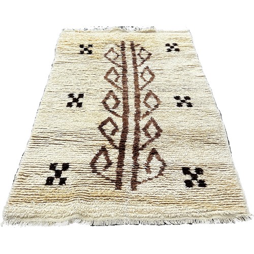 1759 - A Tulu Rug from Turkey with a cream tuffty pile with a central abstract pattern, 190 x 108cm approxi... 