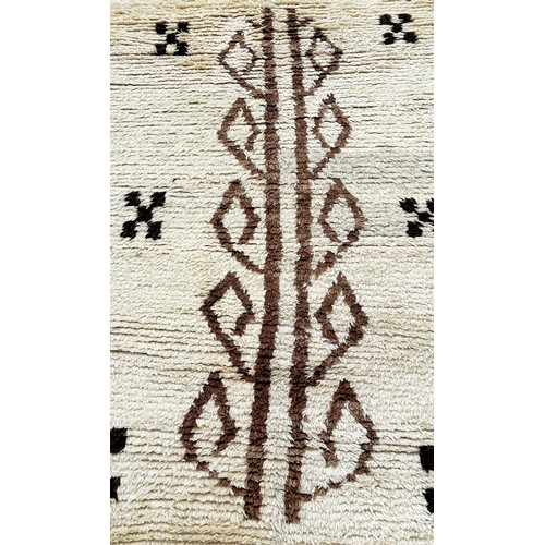 1759 - A Tulu Rug from Turkey with a cream tuffty pile with a central abstract pattern, 190 x 108cm approxi... 