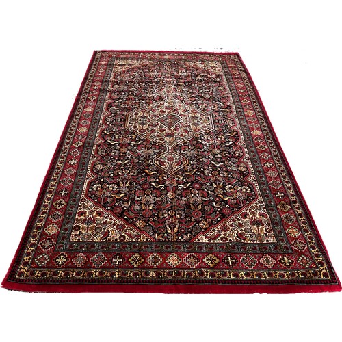 1781 - A Machine made Persian style carpet with an extended central medallion on a floral ground 298 x 150 ... 