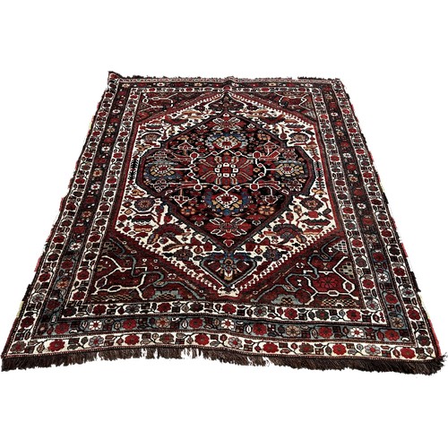 1767 - A South Persian Tribal Rug with a large central stylised floral medallion, 200 x 158cm approximately