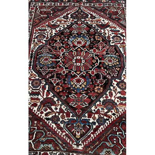 1767 - A South Persian Tribal Rug with a large central stylised floral medallion, 200 x 158cm approximately