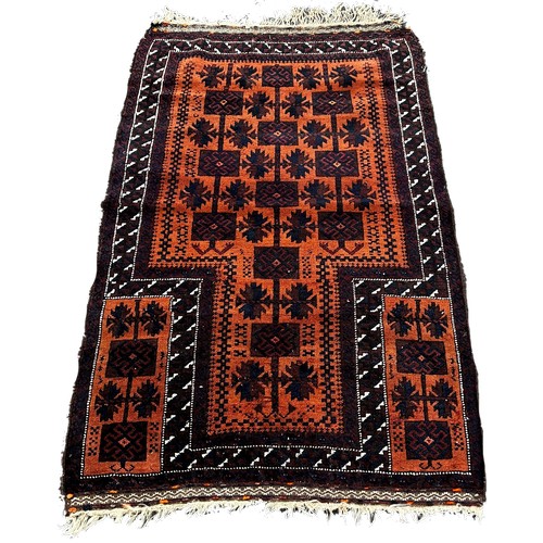 1771 - A Baluch Rug with black interlocking squares on an orange ground, 140 x 80cm approximately