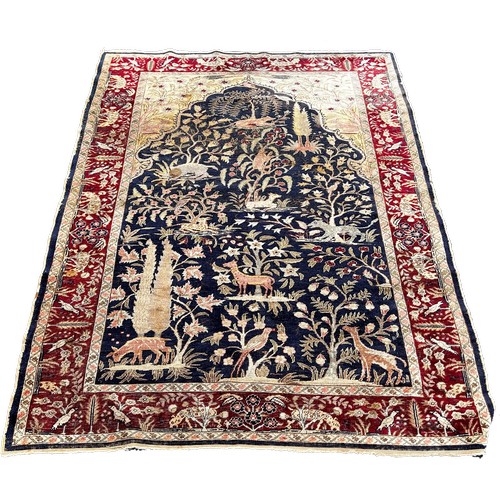 1763 - An Antique Silk Persian Rug with wild animals amongst foliage, 157 x 114cm approximately