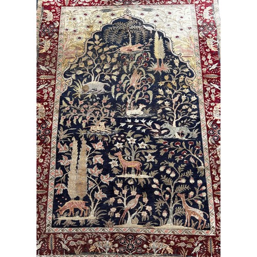 1763 - An Antique Silk Persian Rug with wild animals amongst foliage, 157 x 114cm approximately