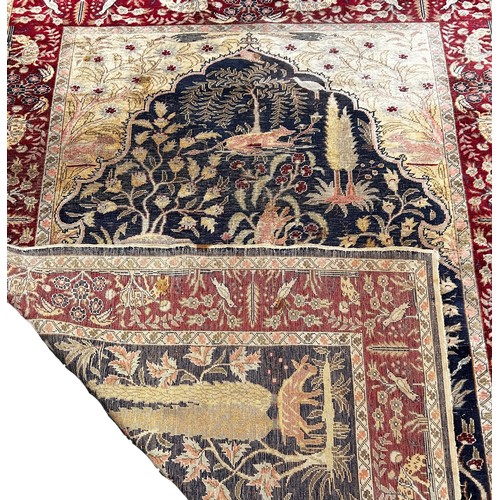 1763 - An Antique Silk Persian Rug with wild animals amongst foliage, 157 x 114cm approximately