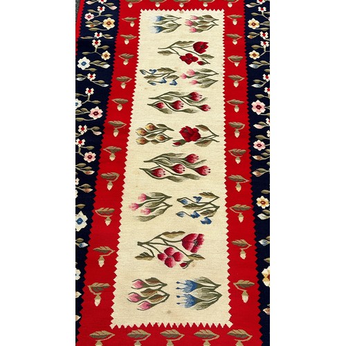 1751 - A Scandinavian kilim with a central panel of flowering plants and a blue border with further flowers... 