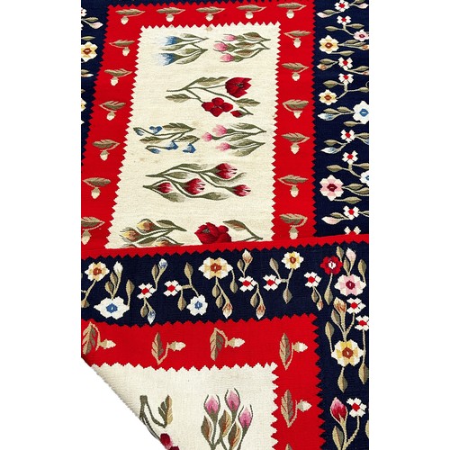 1751 - A Scandinavian kilim with a central panel of flowering plants and a blue border with further flowers... 