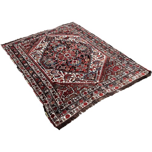 1767 - A South Persian Tribal Rug with a large central stylised floral medallion, 200 x 158cm approximately