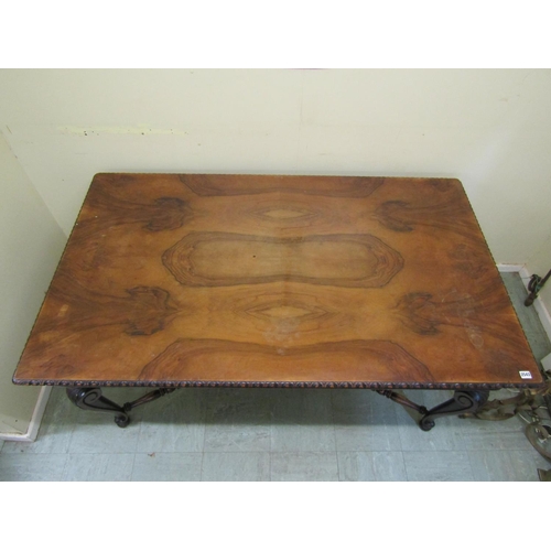 1717 - A walnut dining table of rectangular form with figured top and moulded edge raised on scrolled cabri... 