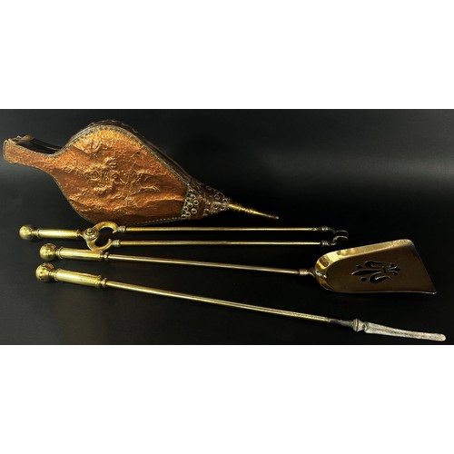 609 - A set of three 19th century brass fire tools, poker, tongs, shovel and a beaten copper  bellows