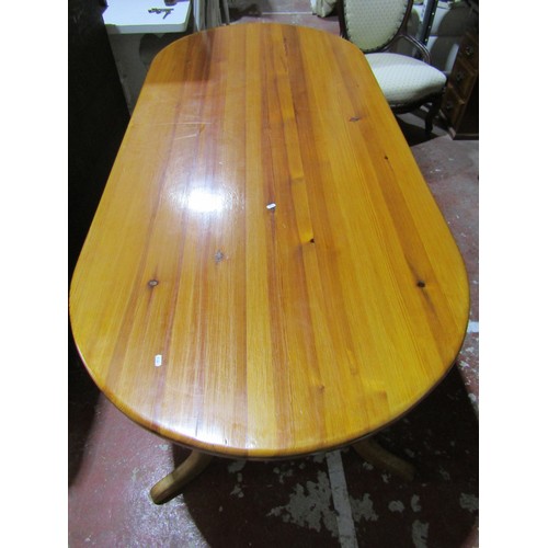 1718 - A contemporary pine kitchen table, the oval top raised on a stretcher base with central rail, 210cm ... 