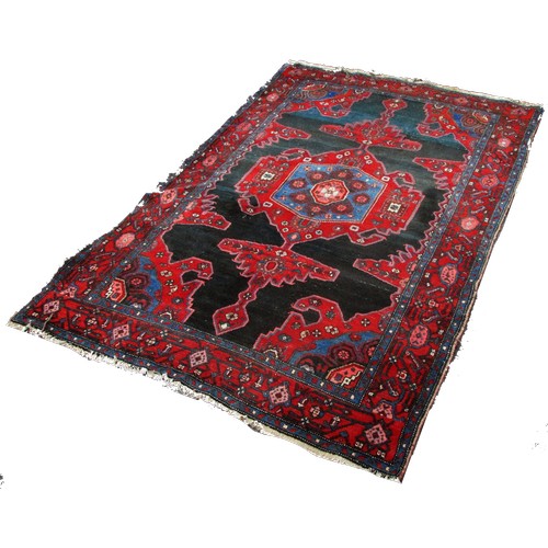 1776 - An old Sharaghan rug with an extended stepped medallion on a black ground, 200cm x 135cm