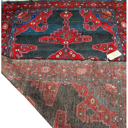 1776 - An old Sharaghan rug with an extended stepped medallion on a black ground, 200cm x 135cm