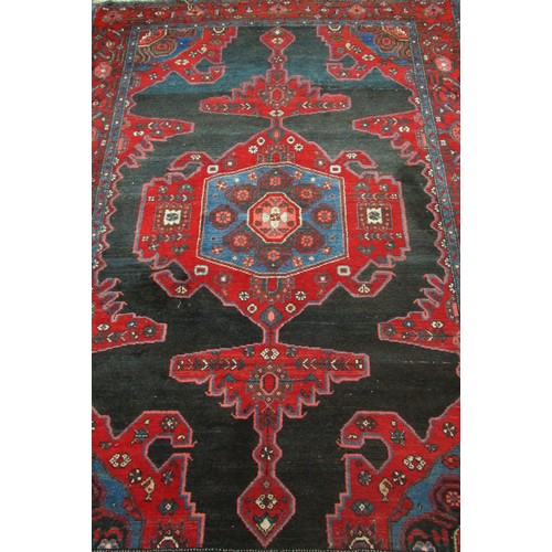 1776 - An old Sharaghan rug with an extended stepped medallion on a black ground, 200cm x 135cm