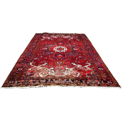 1783 - An old Azerbaijan carpet with a central radiating medallion on a predominantly red ground, faded at ... 