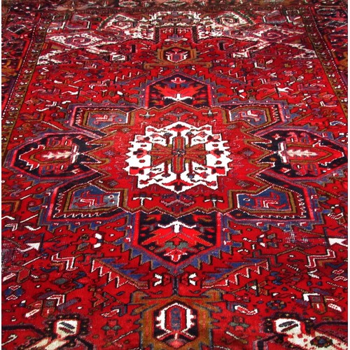 1783 - An old Azerbaijan carpet with a central radiating medallion on a predominantly red ground, faded at ... 