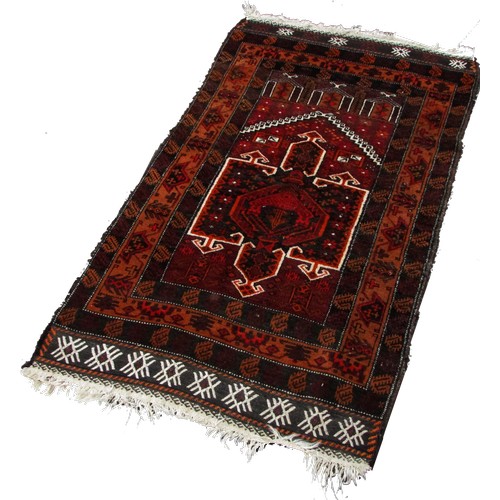 1786 - An Antique Afghan Baluch prayer mat in tones of red and orange, 83cm x 50cm approximately