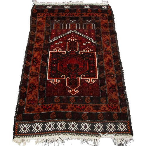 1786 - An Antique Afghan Baluch prayer mat in tones of red and orange, 83cm x 50cm approximately