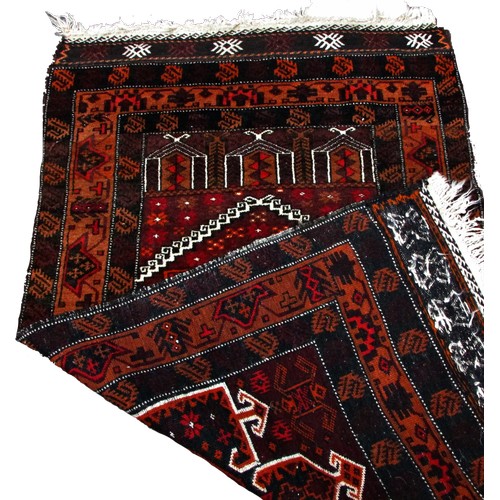 1786 - An Antique Afghan Baluch prayer mat in tones of red and orange, 83cm x 50cm approximately