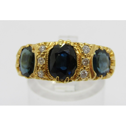 335 - Antique style 18ct claw set three stone sapphire and diamond ring with engraved detail to shoulders,... 