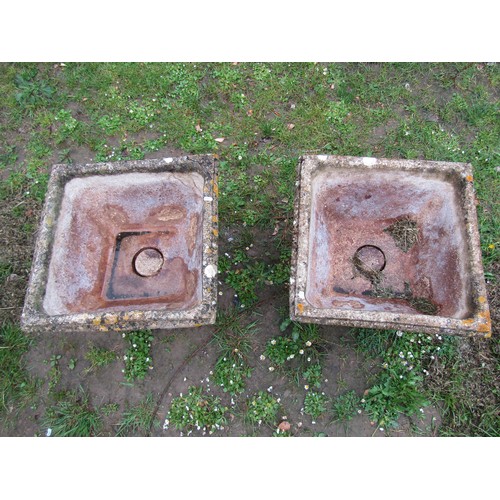 1194 - A pair of weathered cast composition stone garden urns, the square tapered bowls with repeating rose... 