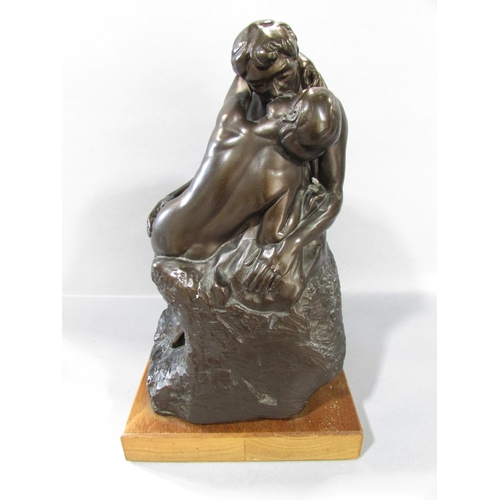 523 - “The Kiss” after Rodin in a bronzed resin finish, set on a wooden plinth, 30cm high over all.