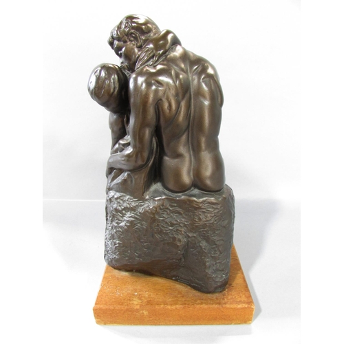 523 - “The Kiss” after Rodin in a bronzed resin finish, set on a wooden plinth, 30cm high over all.