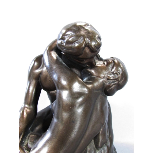 523 - “The Kiss” after Rodin in a bronzed resin finish, set on a wooden plinth, 30cm high over all.